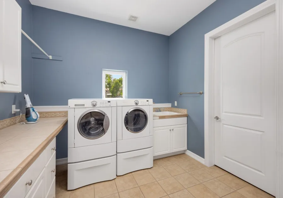 Washer and dryer side by side in a bright home laundry room